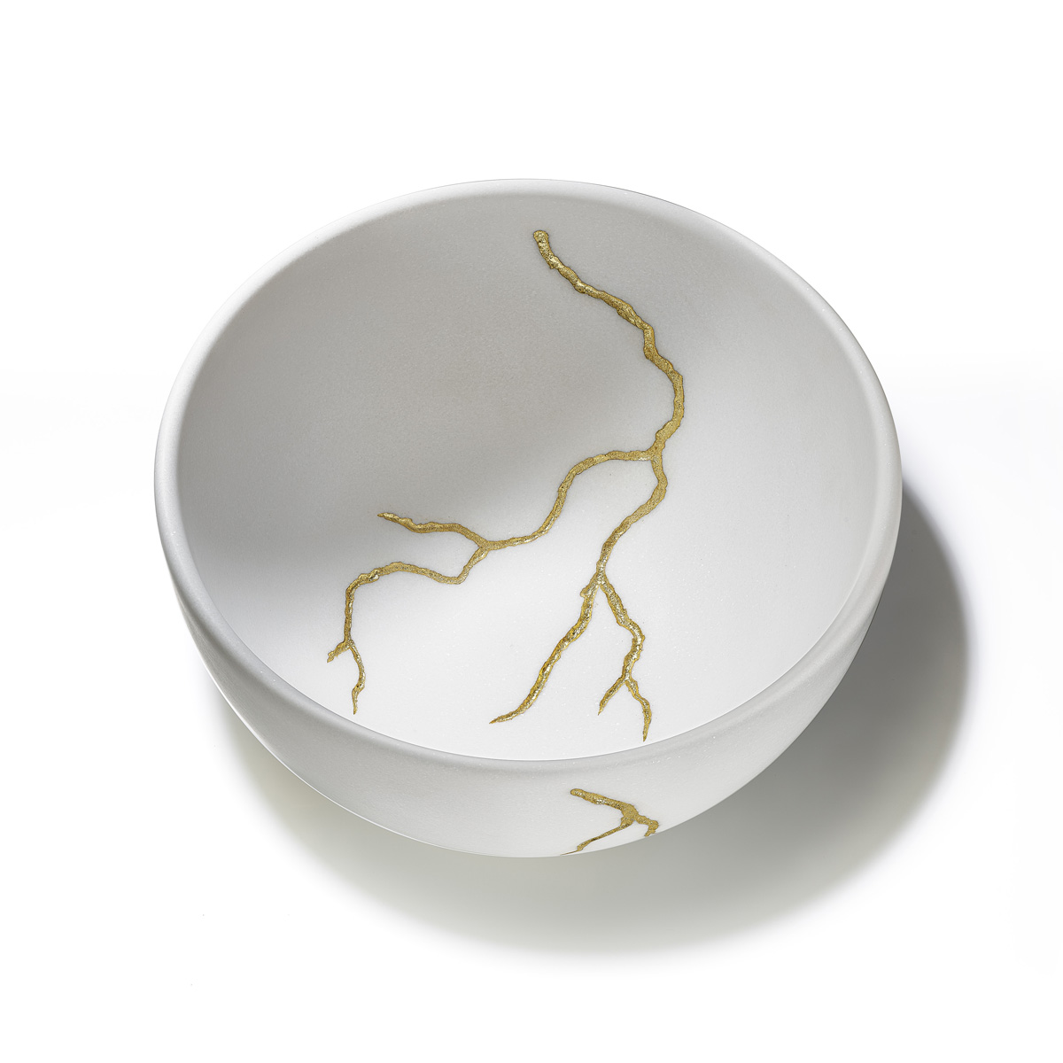 White marble bowl with a gold lightning drawing