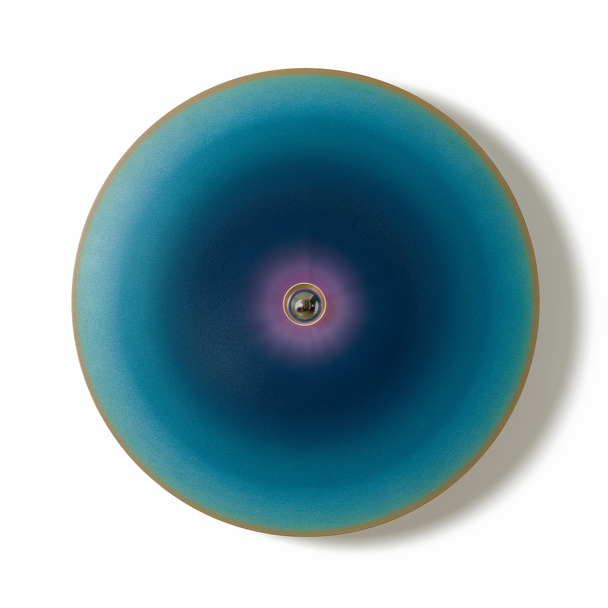 a large disc painted in a concentric shade of blue