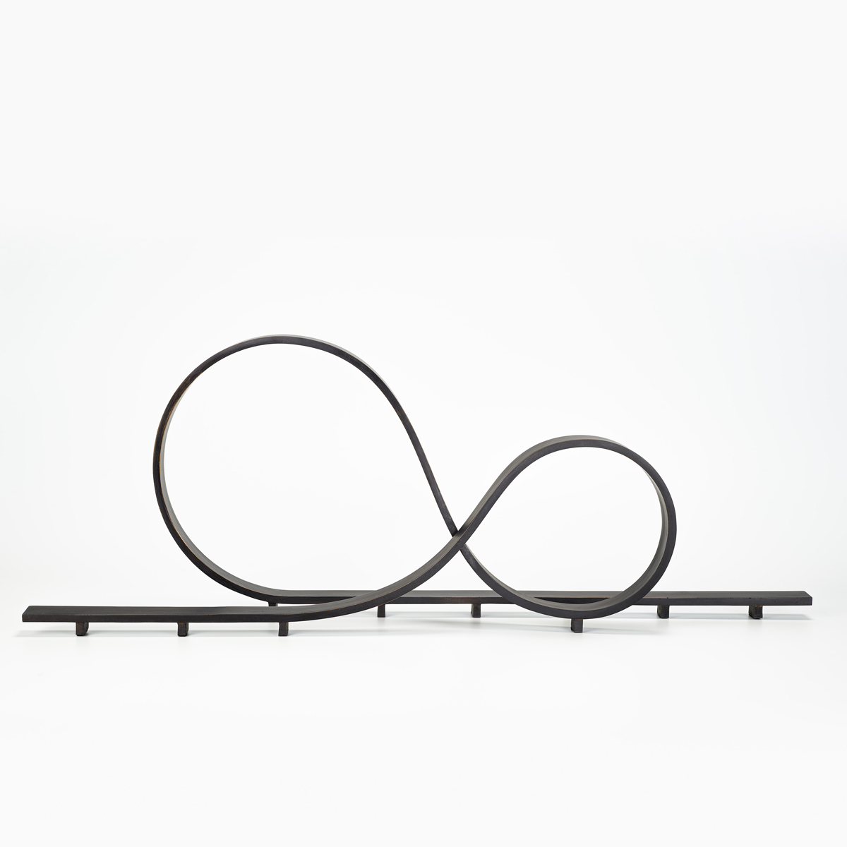 dark patinated bronze ribon like sculpture